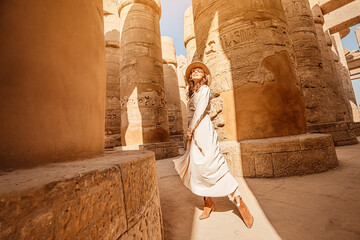 Woman traveler explores the ruins of the ancient Karnak temple in the city of Luxor in Egypt. Great...