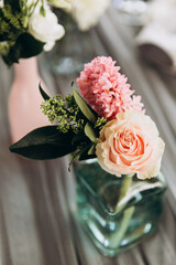 Wedding. Banquet. Decor. Festive tables are decorated with fabric, compositions of flowers and greenery in glass vases, there are candles, glasses, plates and cutlery on the tables