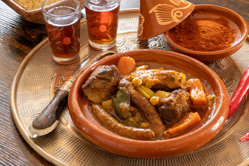 view of a royal couscous composed of chicken, lamb, merguez on a platter