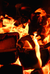 Fire. Photo of flames devouring firewood in a stone fireplace. The texture of the fire in the fireplace. Burning wood inside traditional oven