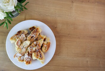 Home baking. Croissants on a white plate. Home, rural cozy kitchen table. Breakfast. Place for text. Delicious. Sweet food. Selective focus