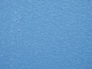 Blue frost texture on the surface. Winter background. Template for product display. Ice texture background. Frost, ice surface. Close up of decorative winter frozen pattern.