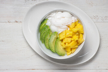 Es Teler, traditional Indonesian ice dessert made from tropical fruit cocktail in sweet coconut water and condensed milk.