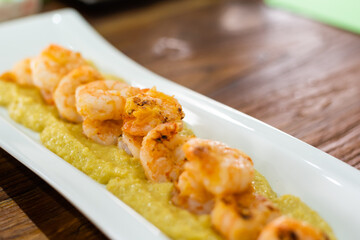 Prawns with garlic. Popular dish of Spanish cuisine. The ingredients are peeled prawns, garlic and olive oil. Served in clay pot They must be eaten quickly, without getting them to cool down.