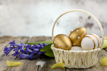 Colorful Easter eggs and hyacinths on wooden background