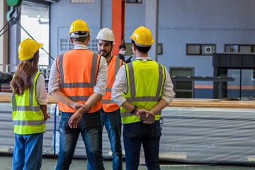 Team Foreman or Team worker work at factory site check up machine or products in site. Team...