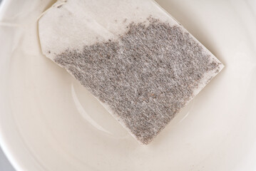 The tea bag is in the cup closeup