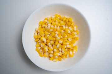 Close up of Corn kernel in white bowl on isolated white backgound