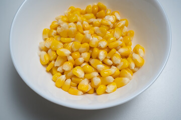 Close up of Corn kernel in white bowl on isolated white backgound