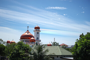 The brick color dome of the mosque in Meulaboh is visible from a distance.