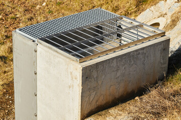 A drain for rainwater. It is used for draining the water from the fields and hills. - obrazy, fototapety, plakaty