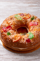 Three kings day cake or bread on rustic background, top view