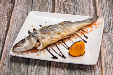 Grilled seabass fish served lemon