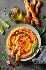 Tasty and homemade tomato hummus made of healthy ingredients.