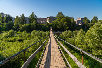 Russia. June 20, 2021. Hanging rope bridge across the Msta River in Borovichi.
