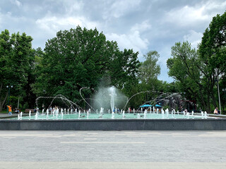 Fountain in the pond in the Shevchenko City Garden in Kharkiv, Ukraine in summer cloudy day	