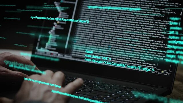 Programmer's hands and laptop keyboard close-up. The developer writes the application code