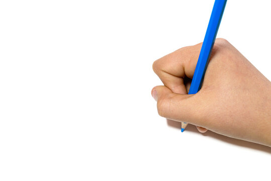 Girl's hand writing with a blue pencil on a white sheet