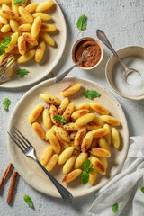 Tasty and hot potato dumplings fried with butter and sugar.