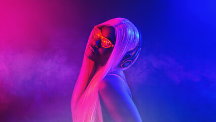 Stylish fashion african teenager model wearing headphones listening dj music dancing in purple neon...