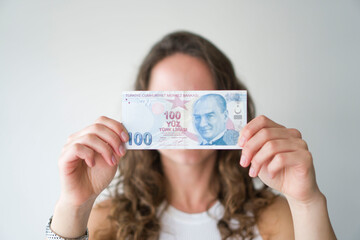 The girl shows the Turkish liras.