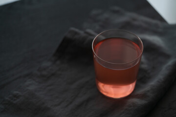 Berry lemonade in tumbler glass on linen cloth