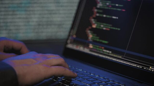 Programmer's hands and laptop keyboard close-up. Working on a project on a laptop.