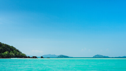 Fototapeta na wymiar Scenic view of peaceful white sand bar and crystal clear turquoise water against clear blue sky. Koh Kham Island, Near Koh Mak Island, Trat Province, Thailand. Minimal panorama.