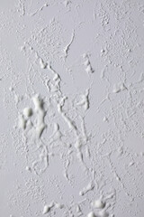 Texture of white soap foam with bubbles abstract grey background, Soap, shower gel, shampoo, Face Cream cleansing mousse sample.