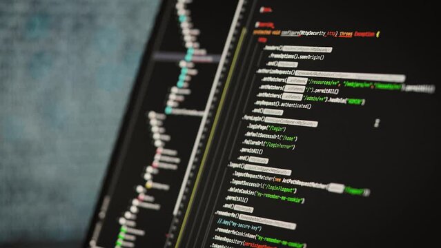 Software development in a special editor. On laptop screen code and application interface.
