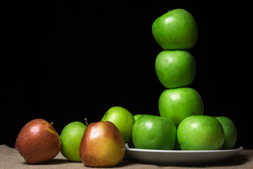 Fresh apples on a black background. Different varieties of apples. ripe fruit