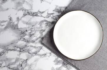 ceramic plate on napkin on white marble table.Flat lay