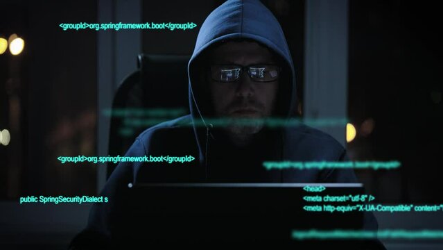 An experienced hacker works with code when breaking into security systems. A programmer is looking for illegal work on the dark web.