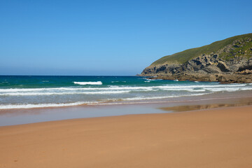 Fototapeta na wymiar A quiet beach with a turquoise blue sea