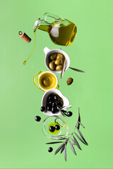 floating extra virgin olive oil with olives