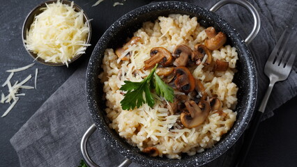 Mushroom risotto garnished with parsley  and parmesan.