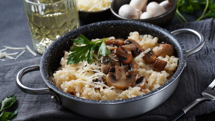 Mushroom risotto garnished with parsley  and parmesan.