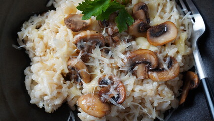Mushroom risotto garnished with parsley  and parmesan.
