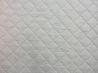 White blanket texture close-up. Blanket texture. Patchwork quilt pattern. White background of square shape.