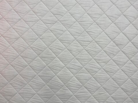 White Blanket Texture Close-up. Blanket Texture. Patchwork Quilt Pattern. White Background Of Square Shape.