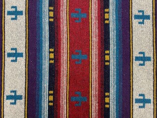 Folk ornament on a blanket. Ethnic tapestry ornament. Close-up colorful rug or carpet. Carpeting...