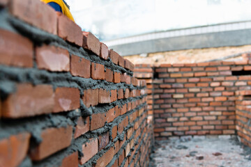 Close up of unfinished red brick wall