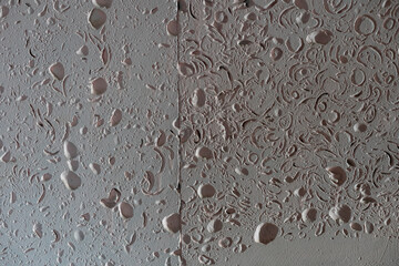 Textured wall lined with shell rock tiles.