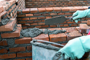 Close up of bricklayer building walls