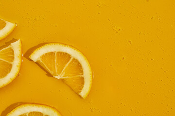 Top view of fresh slice lemons juice and gel serum, organic cosmetics, vitamin C, fresh citrus...