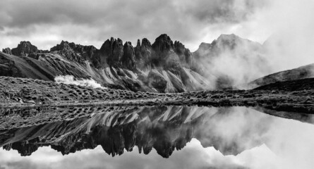 Great alpine panorama with clouds and the reflection of the Stubai Alps in the mirror-smooth...