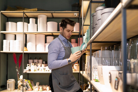 gift shop worker and gift wrapping tidy up the shelves in the store, Inventory concept