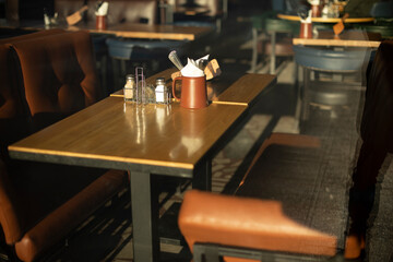 Fototapeta na wymiar Table in restaurant. Place to relax. Brown sofa. Dining table.