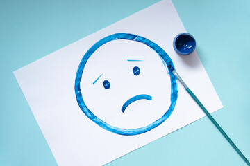 Top view of the drawing sad face.Blue monday and mental health concept.