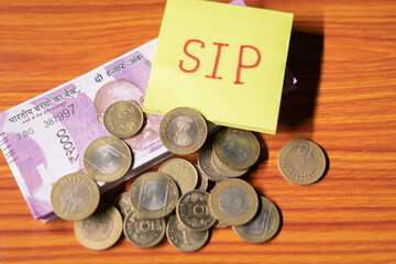 Sip with coin and stack of money table - concept of savings , investment, financial and wealth...